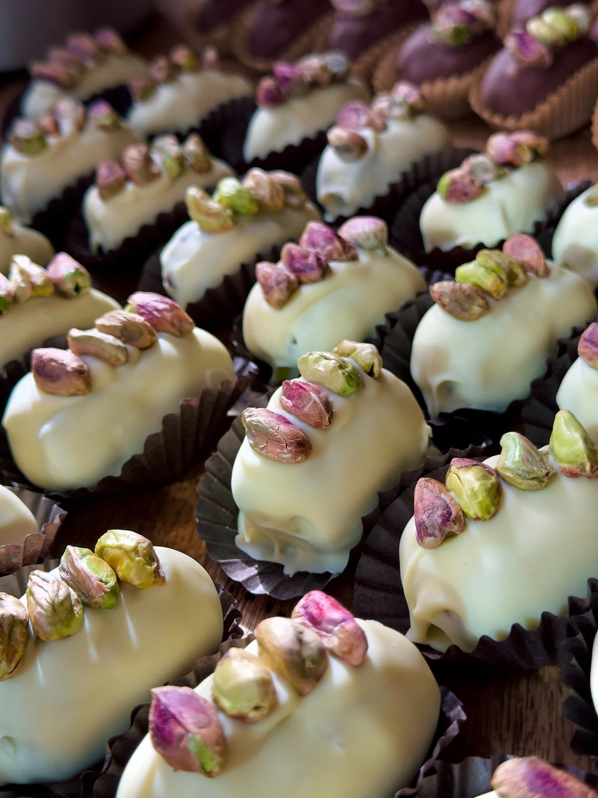 White chocolate Bonibon Dubai dates topped with pistachios